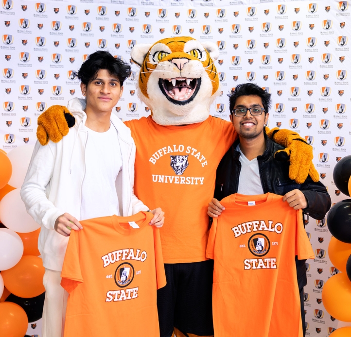 Two students holding t-shirts with the Bengal.