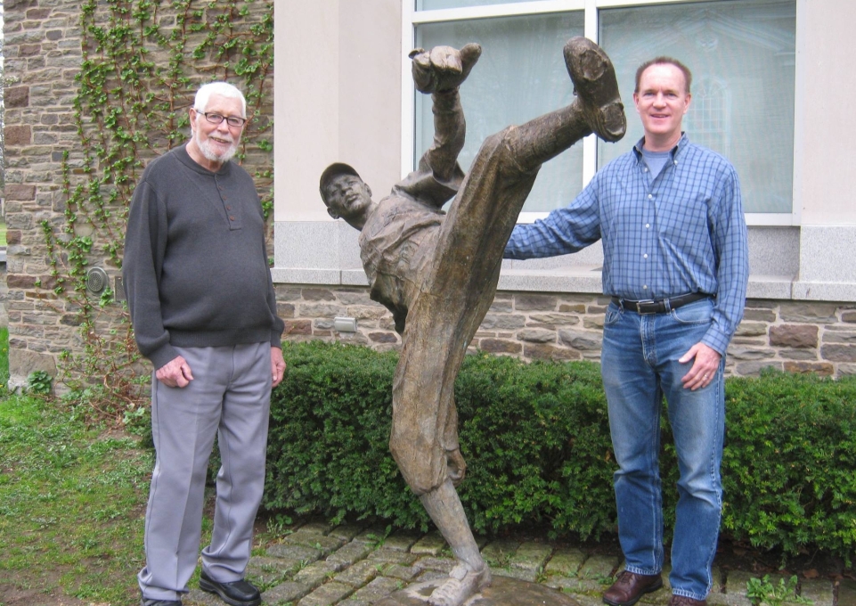 Loren and Jim Keller alongside a statue of Satchel Paige in Cooperstown.
